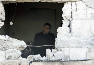Israeli Finance Minister Yair Lapid stands in a house damaged by a rocket, fired by Palestinian militants, that landed in the southern town of Sderot July 21, 2014. Israeli forces killed at least 10 Palestinian militants on Monday after they crossed the border from Gaza through two tunnels, the military said, as the death toll from the two-week conflict passed 500. An Israeli army spokesperson said at least 35 rockets were fired on Monday from Gaza. REUTERS/Baz Ratner (ISRAEL - Tags: CIVIL UNREST CONFLICT POLITICS BUSINESS)